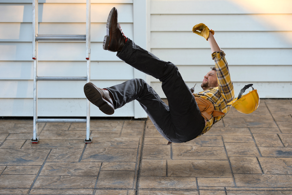 Worker,With,Hard,Hat,Falling,From,Ladder,Onto,Concrete,Floor