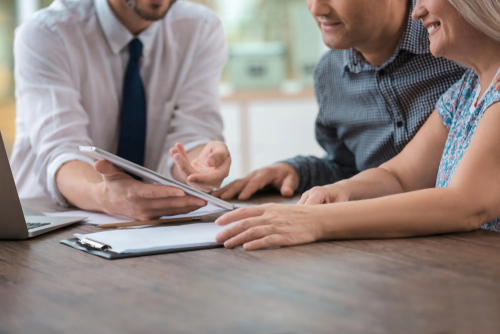 Male,Insurance,Agent,Consulting,Clients,In,Office